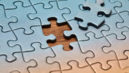 Completed jigsaw puzzle with final piece not in place.