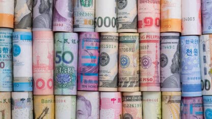 Rolled up high-value paper currency of various countries.