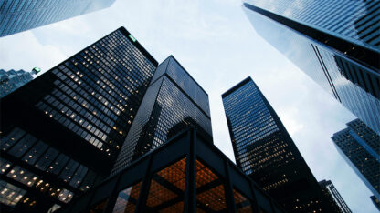 Skyward perspective looking up at a number of skyscrapers.