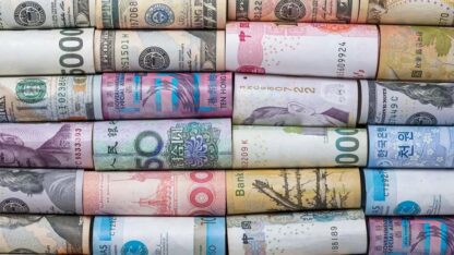 Rolled up paper currency from various countries.
