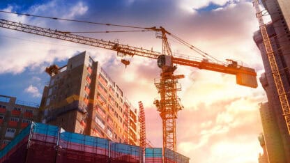 Government building undergoing construction with crane
