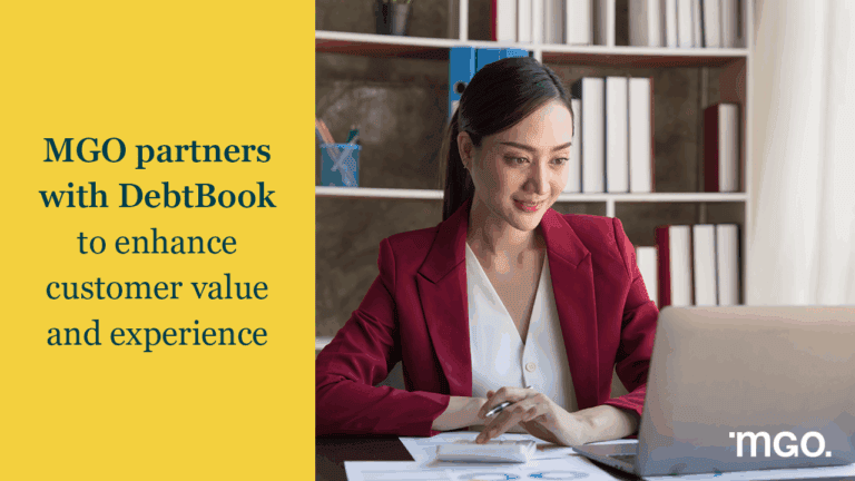 Banner announcing a partnership between MGO and DebtBook next to an image of a woman working a calculator next to her laptop.