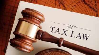 A gavel placed on top of a sheet representing tax law.