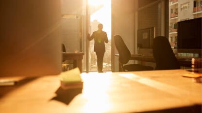 Man standing in the doorway of business office