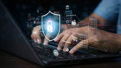 Hands typing with lock logo representing how too many tools can actually weaken cybersecurity