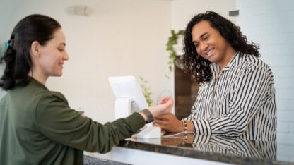 Woman making a payment at a cannabis dispensary