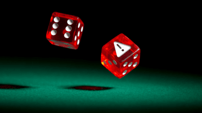 Pair of dice, one with warning sign, representing risks to Tribal casinos posed by legacy technology