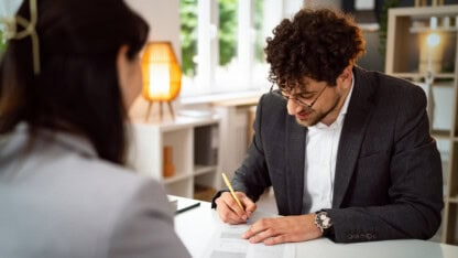 Client signing a contract during a meeting