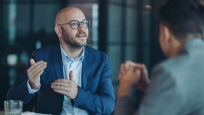Closely held business owner at a conference table exit planning with advisor