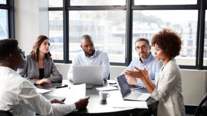 Team of people having a discussion at a table.
